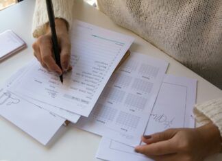 Qué son las pruebas psicométricas: tipos, ejemplos y resultados Persona escribiendo sobre una hoja de papel con un bolígrafo, representación de una prueba de evaluación